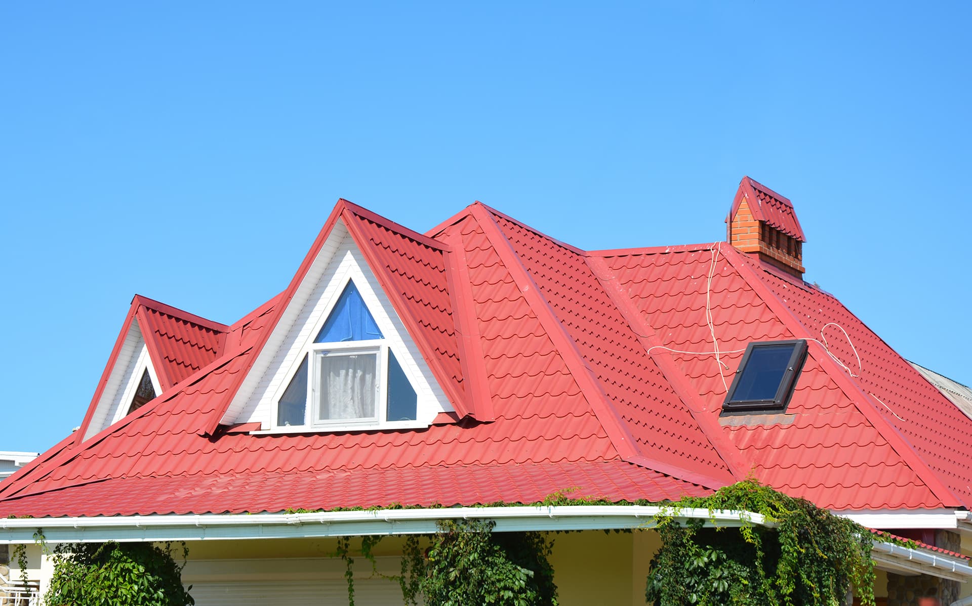 Valley and gable roofing construction with attic windows, rain